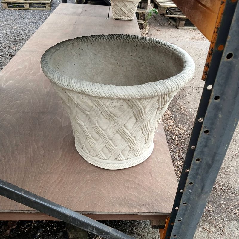 Round tapered planter with a woven basket pattern and rope rim