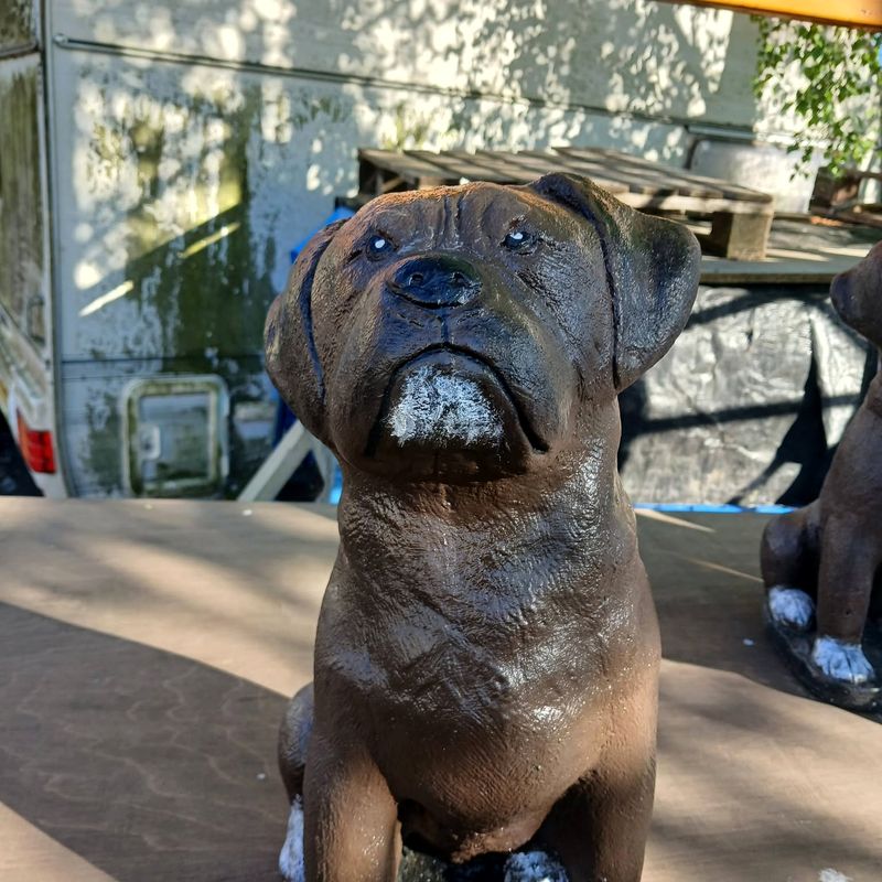 Seated boxer dog statue painted in brindle brown with a white muzzle