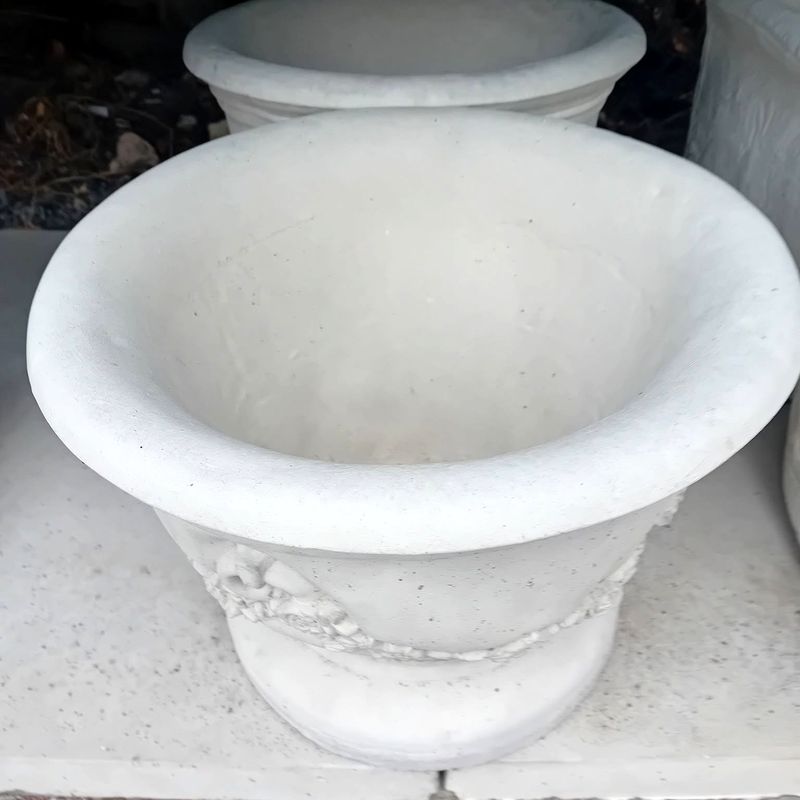 Wide classic urn planter with a rolled rim in pale stone