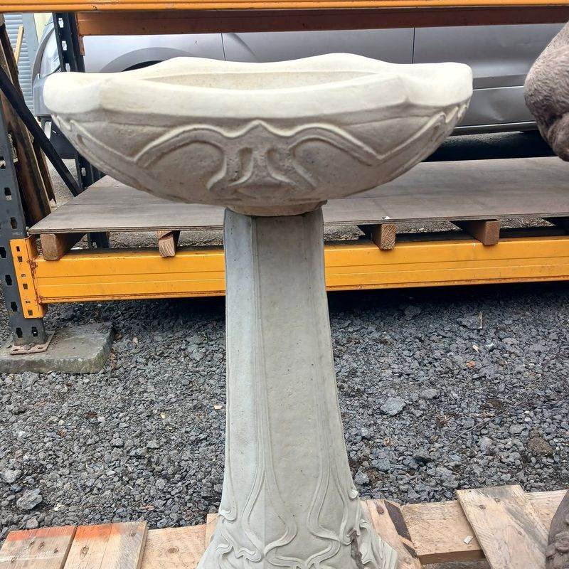 Tall pedestal bird bath with a scalloped bowl