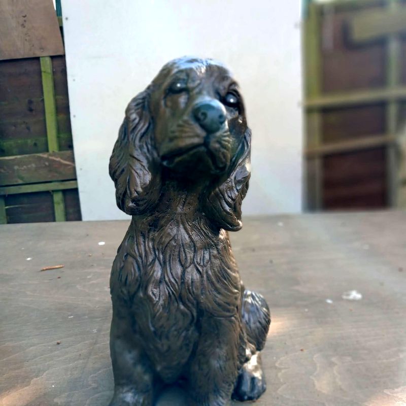 Seated spaniel statue with long ears, painted in dark chocolate brown